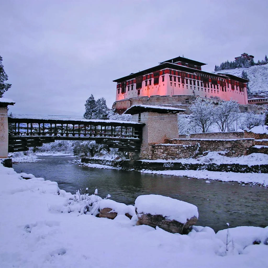 Rinpung Dzong and the covered cantilever bridge in Paro after snowfall