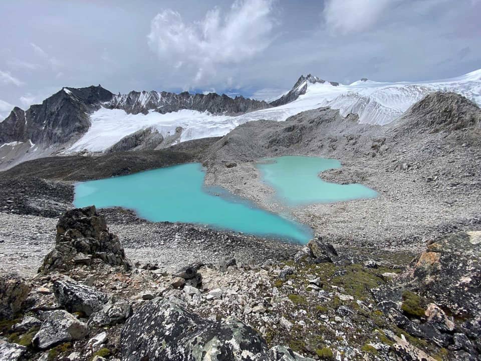 Turquoise glacial lake and mountain trail on a Himalayan trek